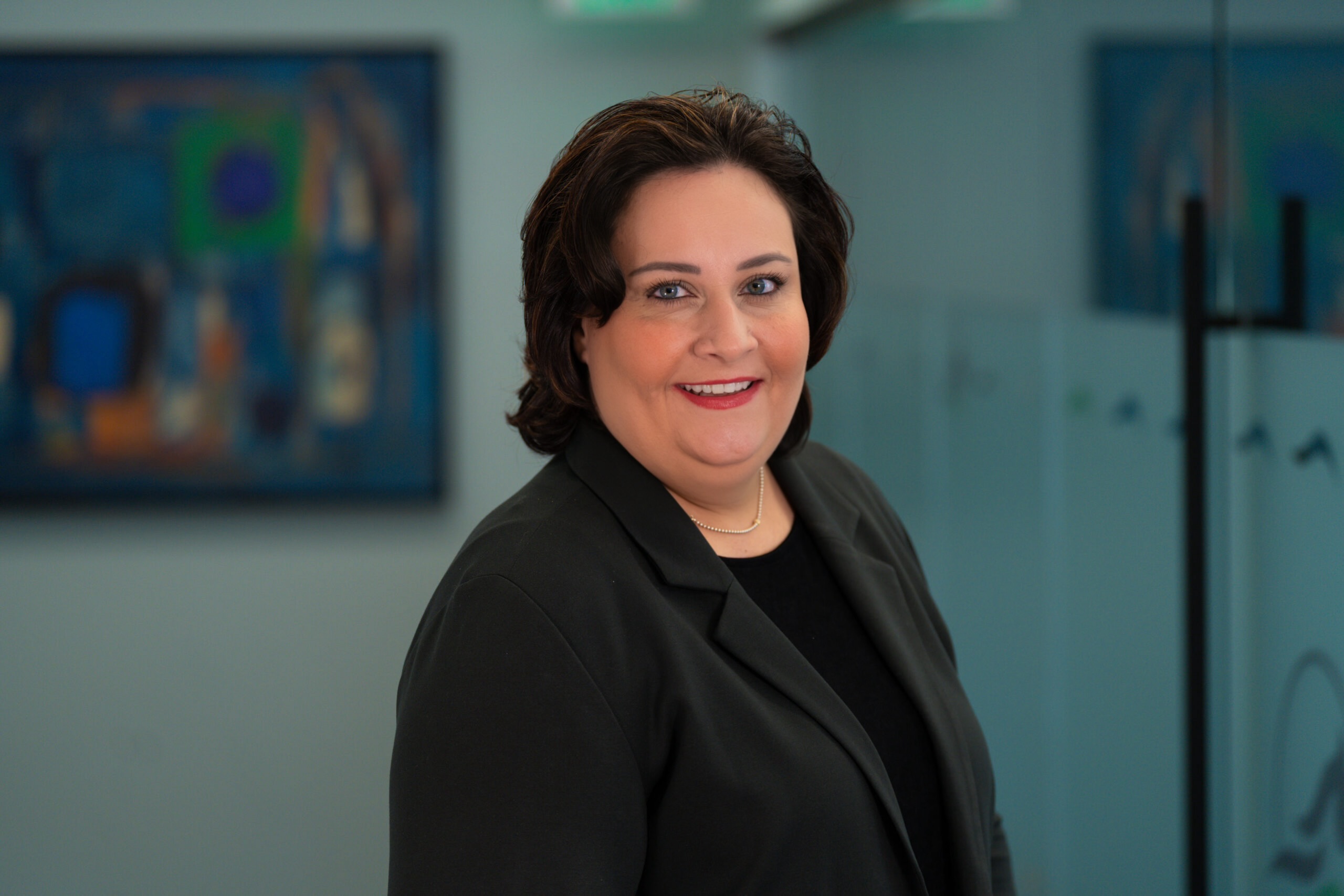 Diana V. Novoselska in black blazer in Horsepower Today office in Omaha Nebraska